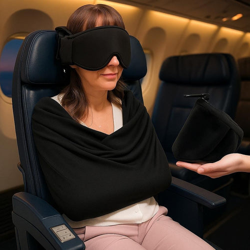 Traveler asleep upright in an airplane seat wearing the Snoozeat sleep set